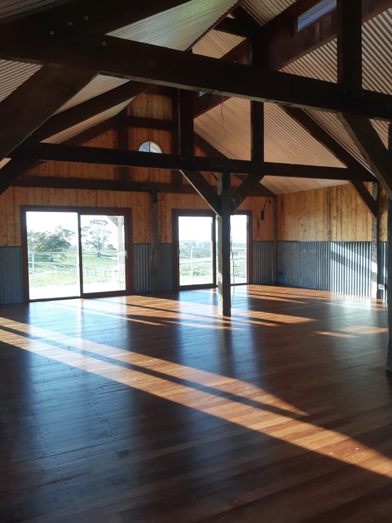 Inside The Barn, with feature trusses made on site from recycled Oregon.